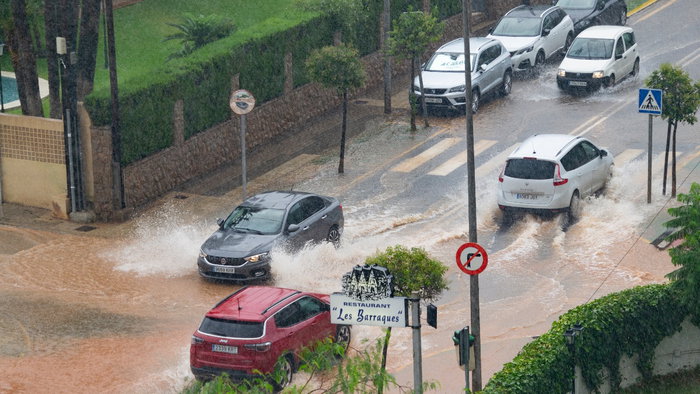 Photos of cars amid heavy rainfall