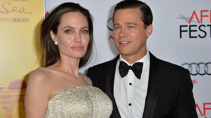 Brad Pitt and Angelina Jolie posing together at a red carpet event