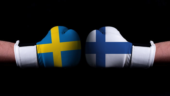 Two hands of wearing boxing gloves with Finland and Sweden flag. Patrik Laine declares Finland’s hate for Sweden ahead of 4 Nation.
