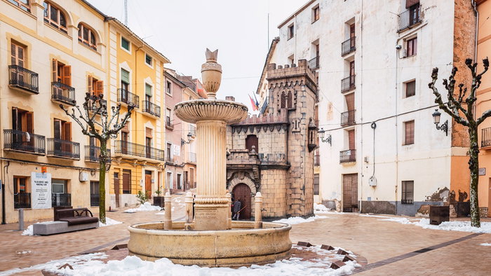 Snow-covered plaza with a fountain in a Valencian town
