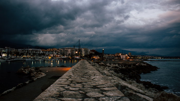 Storm clouds gather over Estepona harbour.