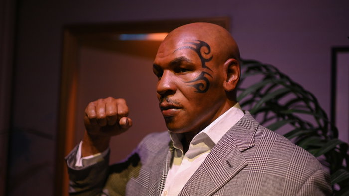 Mike Tyson in a suit making a fist in 2019 in Kansas, USA.