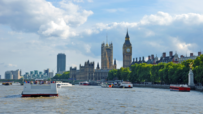 View of River Thames with boats and Big Ben in London.