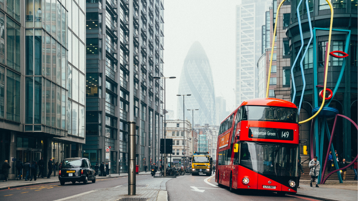London bus near the Gherkin on a cloudy day