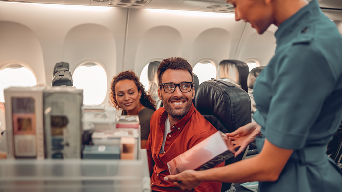 Flight attendant serving a passenger