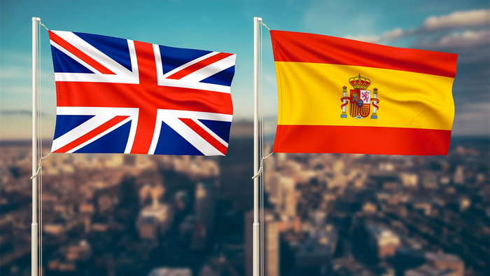 UK and Spanish flags flying side by side, symbolising diplomatic talks on short-term work visa exemptions.
