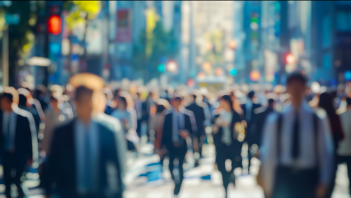 Blurred image of people walking in the street