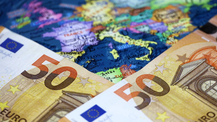 Euro banknotes on a map of Europe