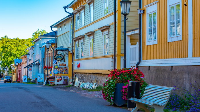 Houses with colourful walls and bench in front of them