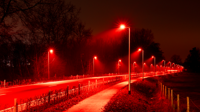 Red streetlights along a main road