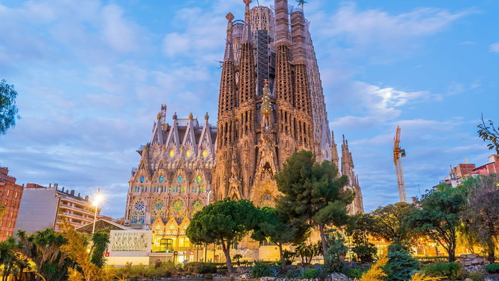 Sagrada Familia basilica in Barcelona reaching full height with cranes still visible during ongoing construction.