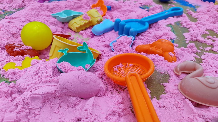Colourful play sand with tools