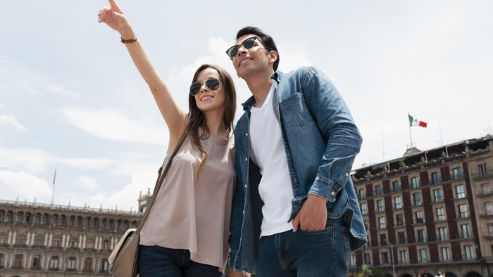Couple of travellers exploring a historic European square while sightseeing together