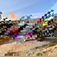 Children from Mojacar stand with the Vieja piñatas made for Dia de la Vieja