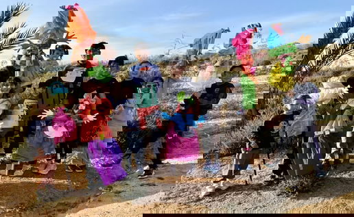 Children from Mojacar stand with the Vieja piñatas made for Dia de la Vieja