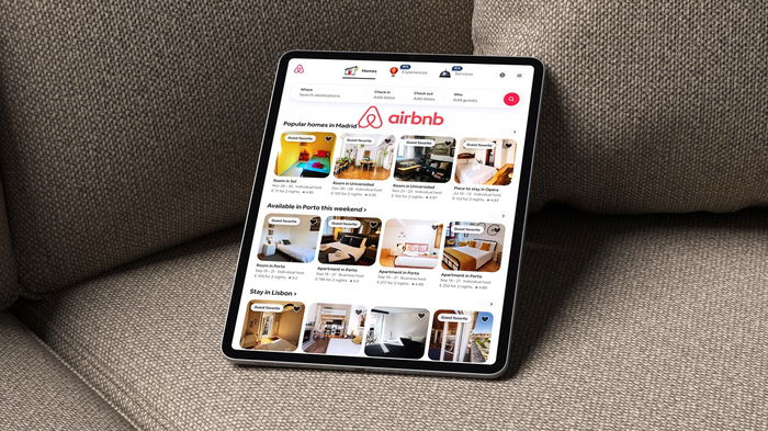 Airbnb app displayed on a tablet showing holiday rental listings in Spain