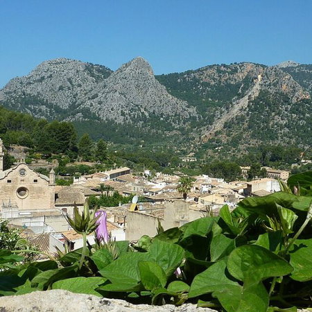 Semana Santa procession at night in Andalucía with penitents in traditional robes and candles