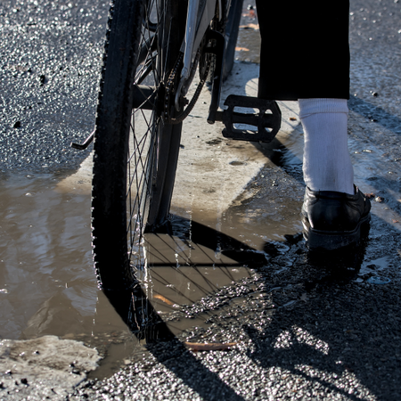 Cyclist riding over cracked asphalt on a rural Spanish road