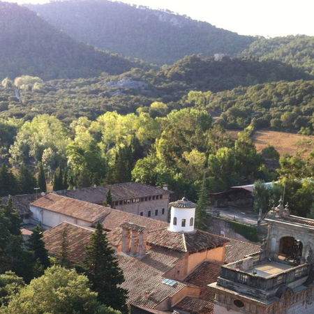 Real estate agent handing over house keys to a new homeowner in front of a property.