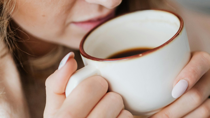 Woman drinking cup of coffee.