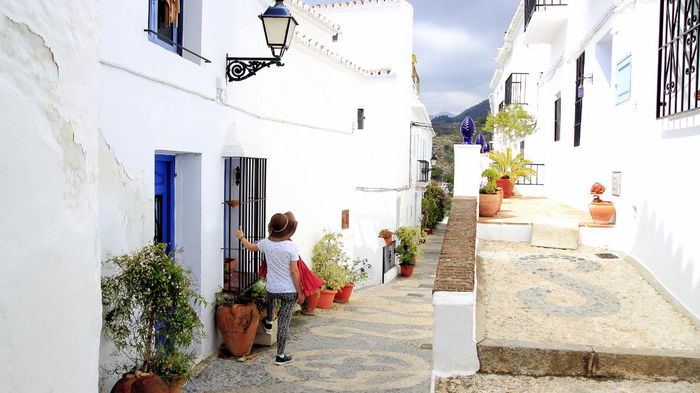 Visitor walking through a narrow street in one of Spain’s most picturesque small towns.