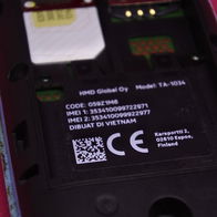 Close-up of a smartphone battery compartment showing the device’s IMEI identification number label.