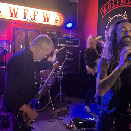 Semana Santa procession at night in Andalucía with penitents in traditional robes and candles