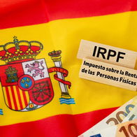 Spain IRPF income tax concept with Spanish flag and euro banknotes