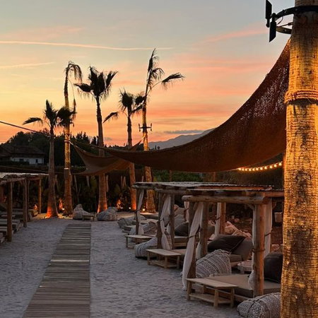 Semana Santa procession at night in Andalucía with penitents in traditional robes and candles