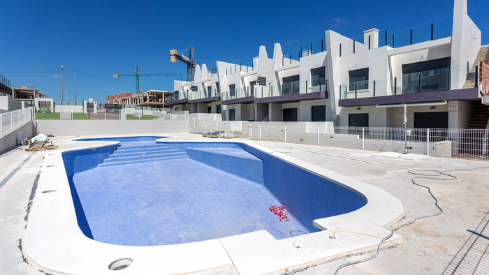 Swimming pool and housing complex being constructed.