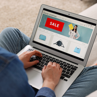 Woman sitting crossed legged with a laptop on her lap