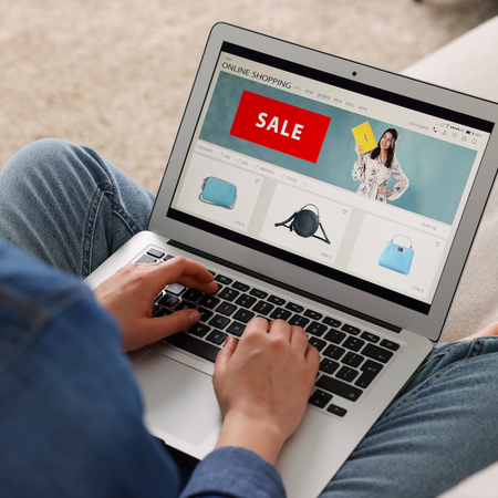 Woman sitting crossed legged with a laptop on her lap