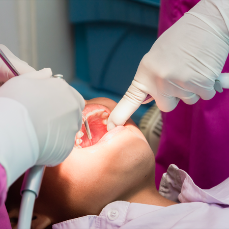 Dentists working on a ypung boys mouth