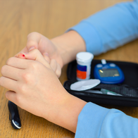 Young person pricking finger for sugar level test