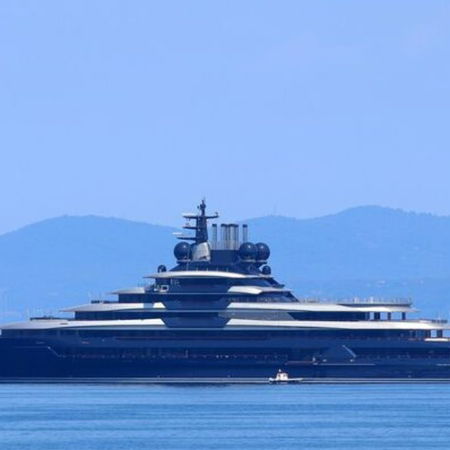 Woman sitting crossed legged with a laptop on her lap