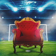 Large comfortable & luxury chair on a football pitch in front of a goal post