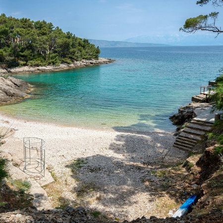 Sandy beach with steps leading down to the sea