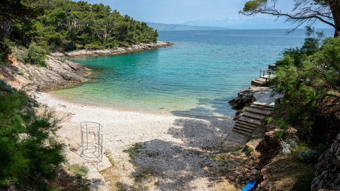 Sandy beach with steps leading down to the sea
