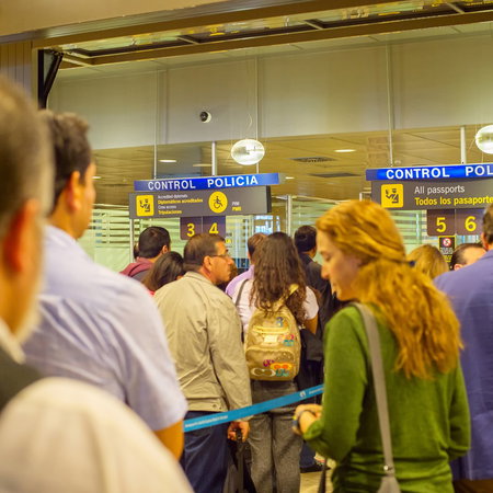 Crowded passport control queue at Madrid airport as passengers wait during peak travel period