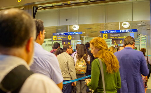 Crowded passport control queue at Madrid airport as passengers wait during peak travel period