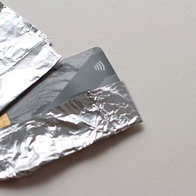 Bank cards wrapped in aluminium foil to block contactless signals and prevent theft in public places