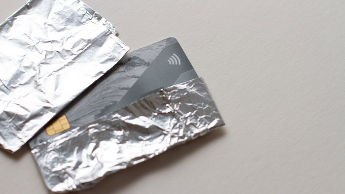 Bank cards wrapped in aluminium foil to block contactless signals and prevent theft in public places