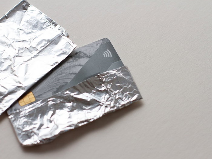 Bank cards wrapped in aluminium foil to block contactless signals and prevent theft in public places