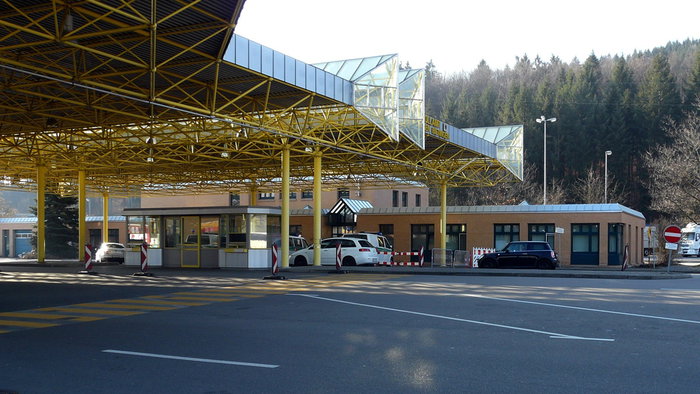 Border crossing checkpoint between Germany and Switzerland with empty lanes and control booths