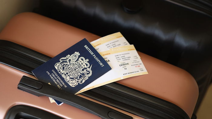 British passport and boarding pass on a suitcase ready for travel