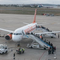 Passengers boarding an easyJet plane on the runway at a Spanish airport