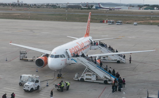 Passengers boarding an easyJet plane on the runway at a Spanish airport