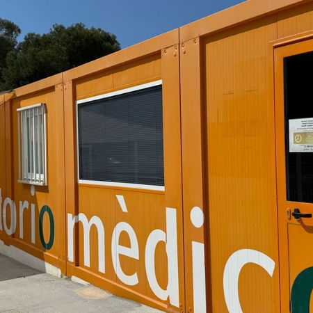 Real estate agent handing over house keys to a new homeowner in front of a property.