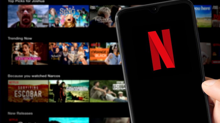 Netflix app open on a smartphone with the platform’s homepage in the background