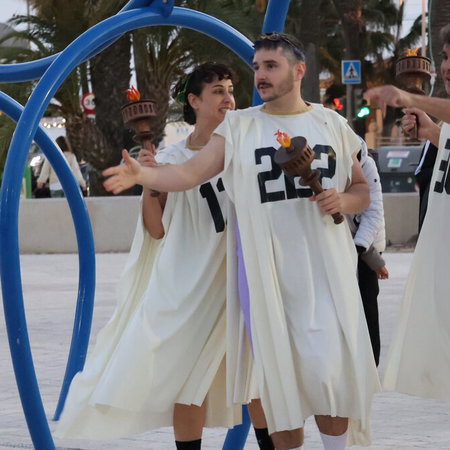 Semana Santa procession at night in Andalucía with penitents in traditional robes and candles